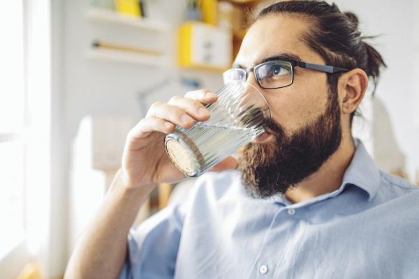 Man drinking a glass of water