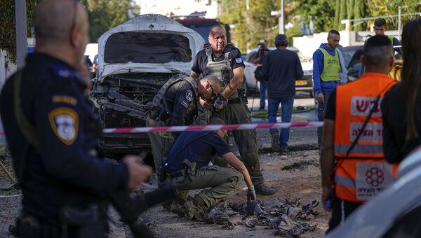 Israeli security forces inspect a site hit by a rocket fired from the Gaza Strip, in Holon, central Israel. Picture: Ariel Schalit/AP Photo