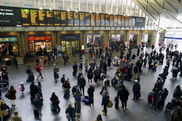 Passengers waiting for trains at London King's Cross Station. 