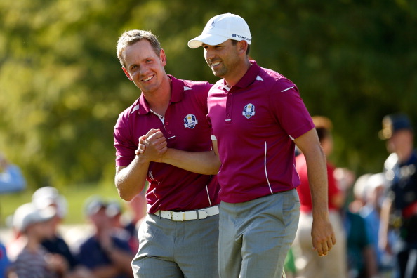 Luke Donald (L) and Sergio Garcia of Europe win the ninth hole during day two of the Afternoon Four-Ball Matches for The 39th Ryder Cup at Medinah Country Club