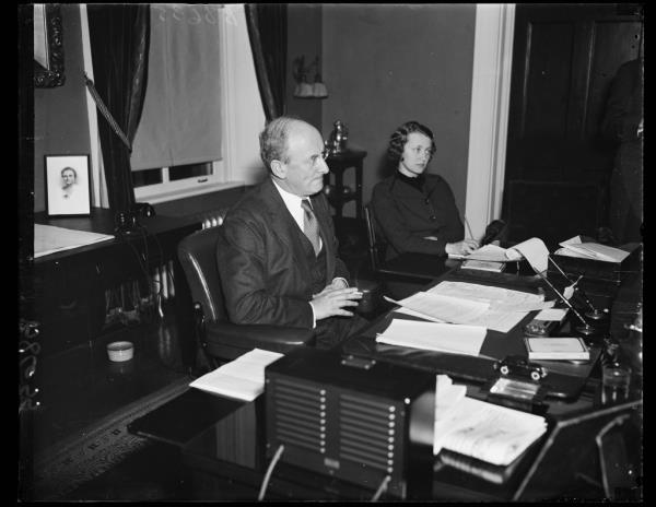 Henry Morgenthau sitting in his office with assistant Henrietta Klotz.