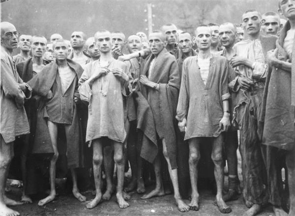 Emaciated people in a concentration camp  