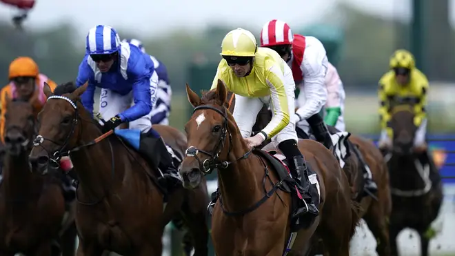 Choisya ridden by jockey Jack Mitchell (centre, in yellow) in winning action at Goodwood