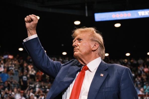 Former US President Donald Trump raising his fist at a campaign rally in Nassau Coliseum, Hempstead, NY in 2024