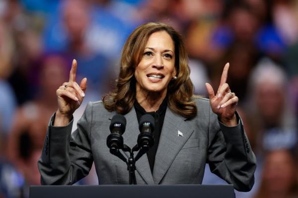 US Vice President Kamala Harris speaking at a podium during a campaign event at Veterans Memorial Coliseum, Madison, Wisconsin