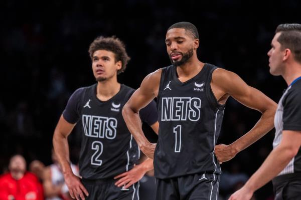 Nets forward Cameron Johnson (2) and forward Mikal Bridges (1) react