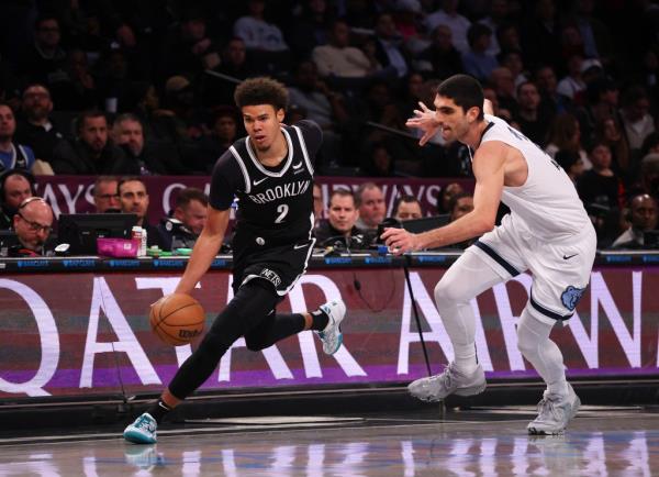 Nets forward Cameron Johnson (2) drives to the basket