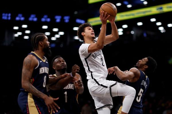 Cameron Johnson #2 of the Brooklyn Nets goes to the basket as Naji Marshall #8, Zion Williamson #1, and Herbert Jones #5 of the New Orleans Pelicans defend