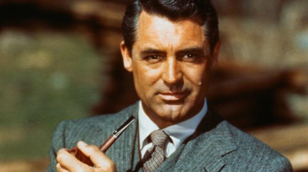 Cary Grant holds a pipe