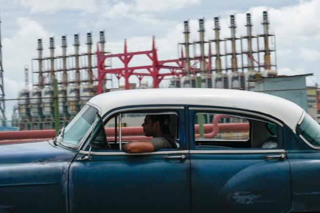 A person drives past a floating generator in Havana on Friday. The generator has not been producing power for several days.