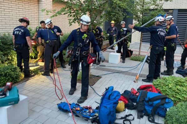 fire and rescue teams rescuing man from pipe