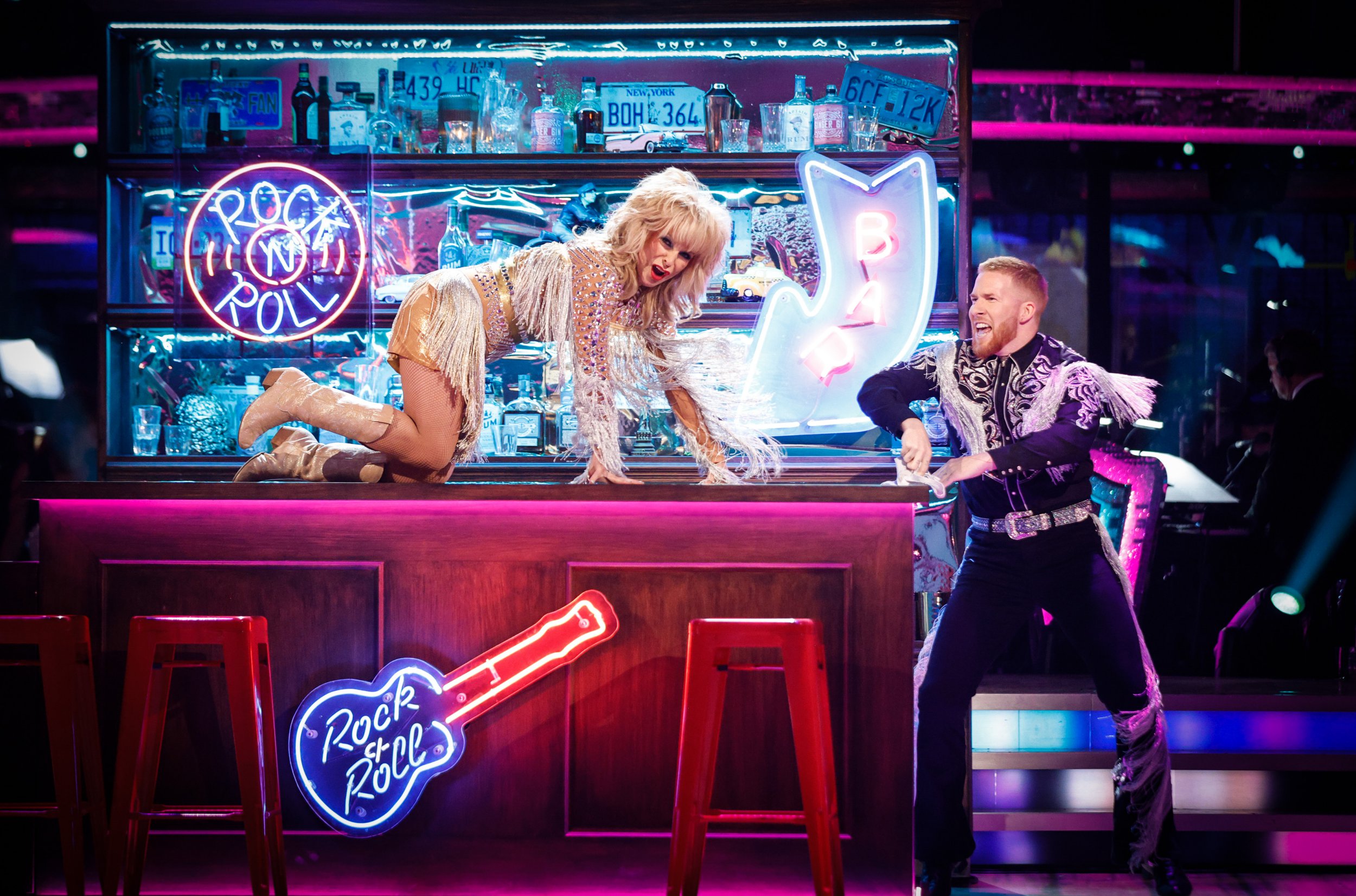 Toyah Willcox and Neil Jones perform on Strictly Come Dancing. Toyah crawls on all fours on top of a bar, while Neil stands to the side