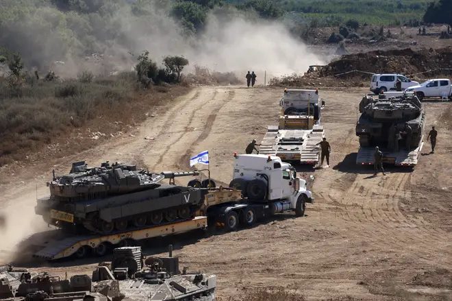 An Israeli tank is transported to a position in the Upper Galilee region of northern Israel