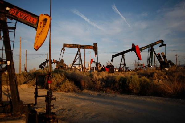 Pump jacks and wells are seen in an oil field on the Monterey Shale formation where gas and oil extraction