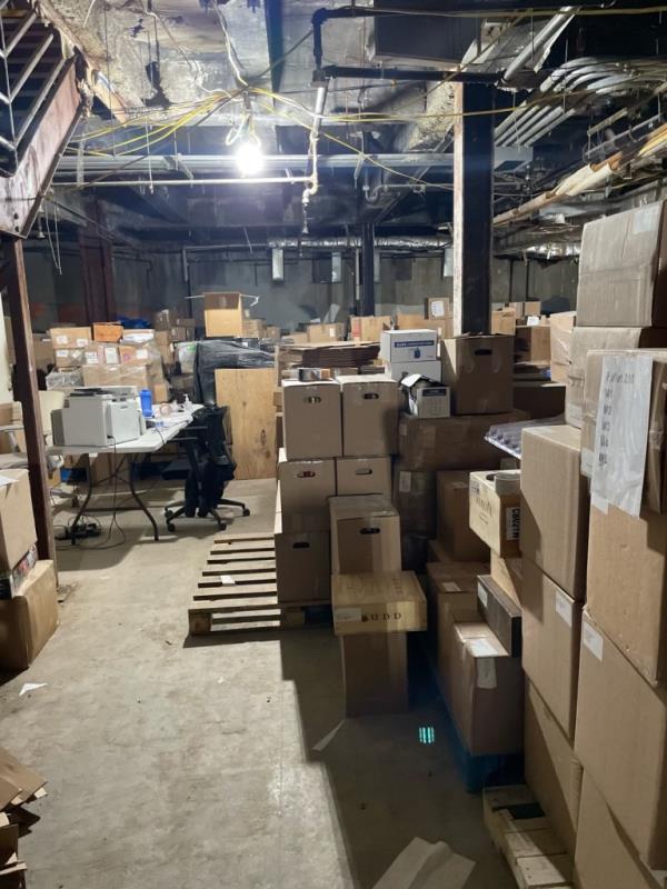 A view of boxes on pallets in the basement.