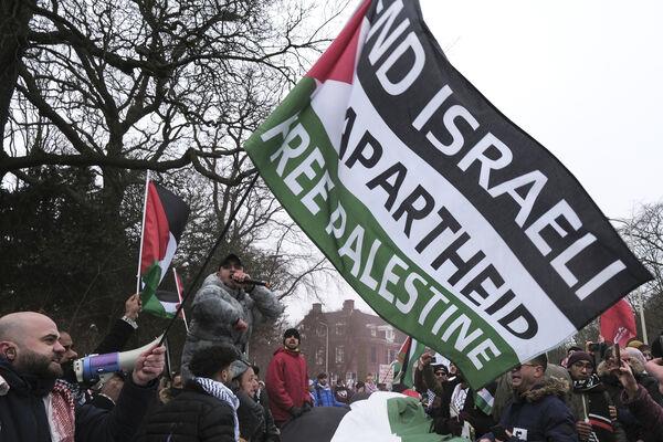 Protestors wave Palestinian flags during a demonstration march outside the International Court of Justice in The Hague, Netherlands, Thursday. Picture: AP Photo/Patrick Post